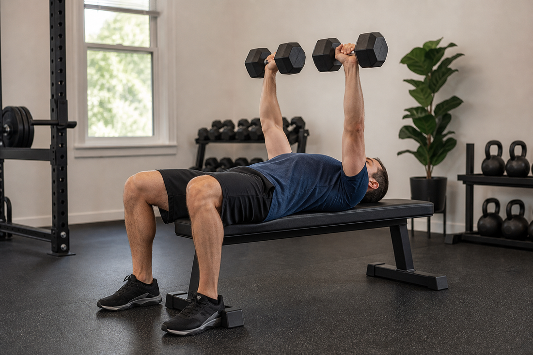 Person performing a controlled dumbbell bench press with feet planted and wrists aligned over the elbows
