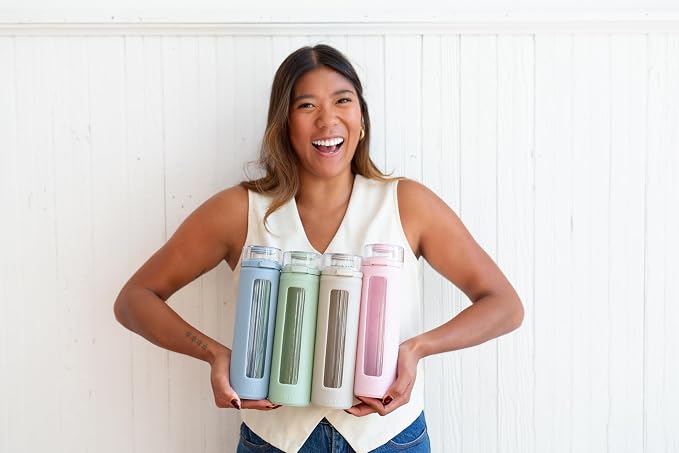 Ello Syndicate 20oz Glass Water Bottle with Flip Lid and Sleeve, Sage | Glass water bottle for iced drinks with leakproof flip lid, silicone sleeve, carry loop, BPA-free, and dishwasher safe